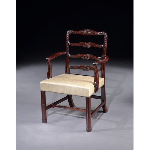 A pair of mahogany ladder back armchairs